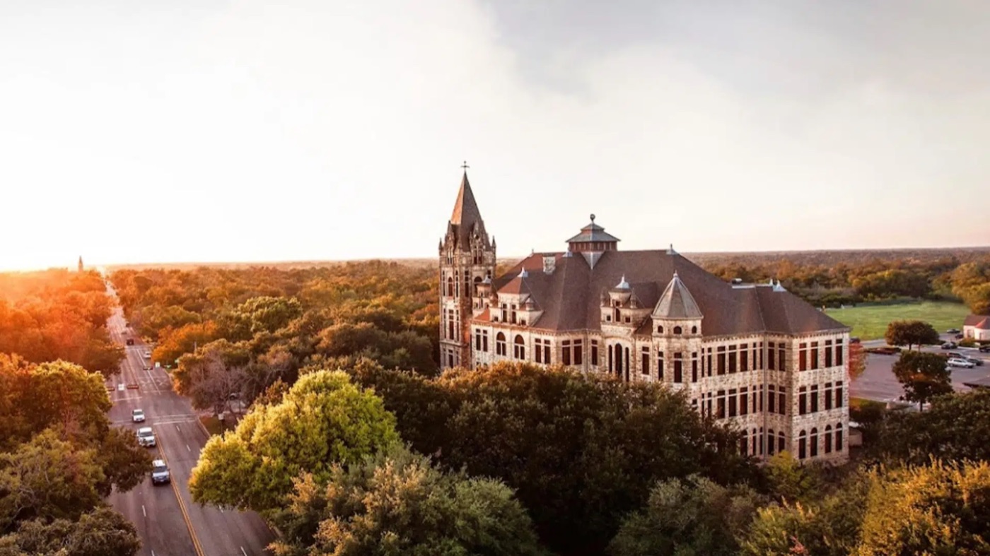 Southwestern University's Cullen Building above the trees of Georgetown, Texas, at sunset